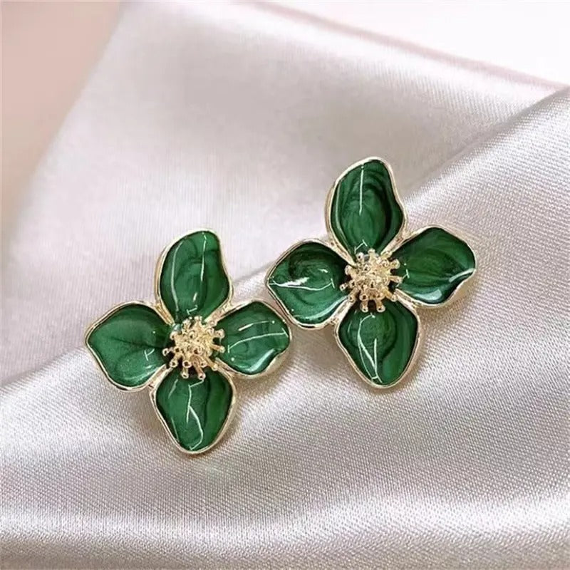 Model draagt Vylaura oorbellen met een elegant bloemenontwerp en subtiele parelmoer afwerking. Deze verfijnde oorbellen geven een romantische en tijdloze uitstraling, perfect voor zowel dagelijkse elegantie als speciale gelegenheden.